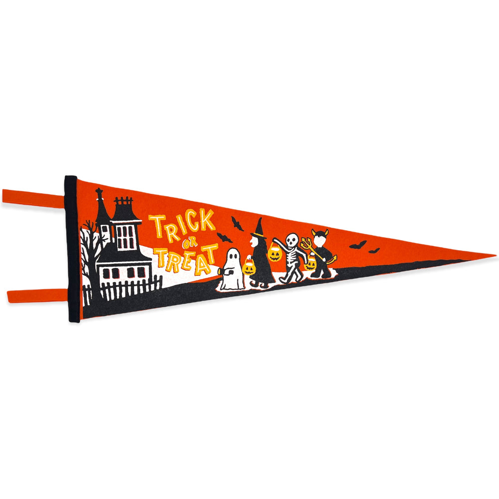 An orange pennant has four trick or treaters, a ghost, witch, skeleton and devil walking towards a spooky house. The words "trick or treat" are written in vintage Halloween font on the pennant.
