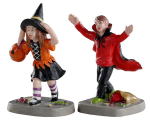 Lemax Spooky Town Terrified Trick-or-Treaters, Set of 2 #02903 at Eerie Emporium - a girl dressed as a witch and a boy dressed as a vampire run with their candy on Halloween night.