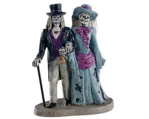 Lemax Spooky Town Spectral Couple #02912 at Eerie Emporium - two ghouls are dressed in purple Victorian Style outfits and walk arm in arm.
