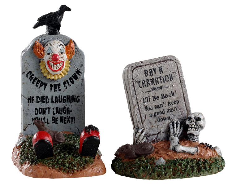 Lemax Spooky Town Crazy Headstones, Set of 2 #04711 at Eerie Emporium - funky and creepy gravestones are covered by a terrifying clown face and a skeleton.