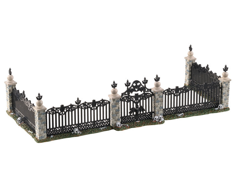 Lemax Spooky Town Bat Fence Gate, Set of 5 #04713 at Eerie Emporium - A stone and wrought iron fence has skulls and bones at its base.
