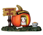 Lemax Spooky Town Pumpkin Doghouse #64053 at Eerie Emporium - a white bulldog sits inside a jumbo pumpkin dog house next to a sign that reads "BEWARE OF DOG"