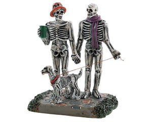 Lemax Spooky Town Moonlight Stroll #82571 at Eerie Emporium - a skeleton couple walks their skeleton dog while holding hands and drinking coffee.