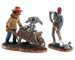 Lemax Spooky Town Ghoulish Gardeners, Set of 2 #82573 at Eerie Emporium - 2 monsters, one skeleton with a red hard hat and one scarecrow, work in a cemetery full of skulls.