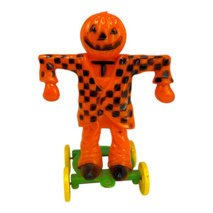 Vintage Halloween Rosbro Plastic Checkered Scarecrow JOL On Wheels ~ Candy Container Toy 1950s at Eerie Emporium. 
