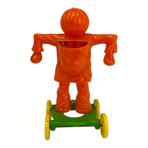 Vintage Halloween Rosbro Plastic Checkered Scarecrow JOL On Wheels ~ Candy Container Toy 1950s at Eerie Emporium. 3