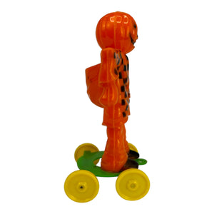 Vintage Halloween Rosbro Plastic Checkered Scarecrow JOL On Wheels ~ Candy Container Toy 1950s at Eerie Emporium. 4