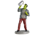 A drunken Frankenstein drinks out of a large silver pint mug.