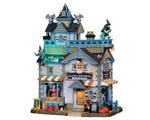 A three story blue and grey boutique is illuminated by yellow lighting. Inside, witches eagerly try on the newest styles, while outside black cats, gargoyles and additional witches stand guard. 