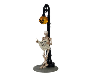 A skeleton leans against a jack-o'-lantern light pole while reading a newspaper titled Horror-Scope.
