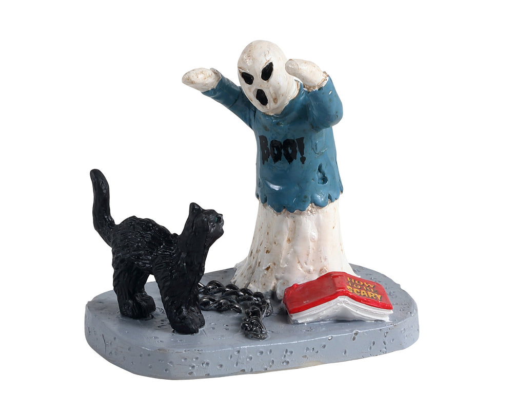 
            
                Load image into Gallery viewer, A young ghost practices his scaring tactics by attempting to scare off a black cat. A book titled how to be scary rests at the ghosts feet.
            
        
