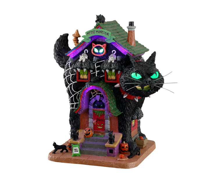 A large black cat makes up the main structure of a purple and green colored house. There are multiple cats on the house and jack o' lanterns. 