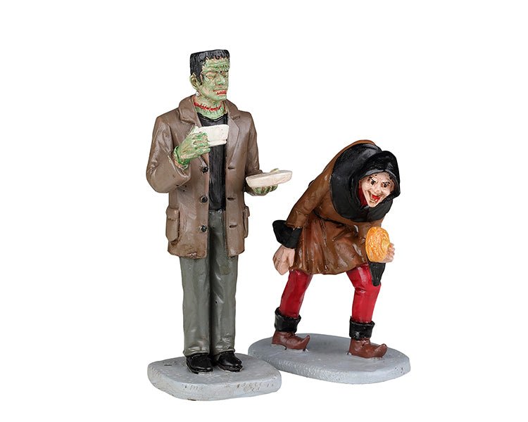 
            
                Load image into Gallery viewer, Frankenstein drinks coffee next to his hunchback monster friend.
            
        