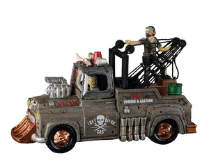 
            
                Load image into Gallery viewer, A rusty mad max style tow truck is driven by a green ghoul with another monster riding in the back of the truck. The side of the truck says, &amp;quot;24/7 Towing &amp;amp; Salvage&amp;quot;
            
        