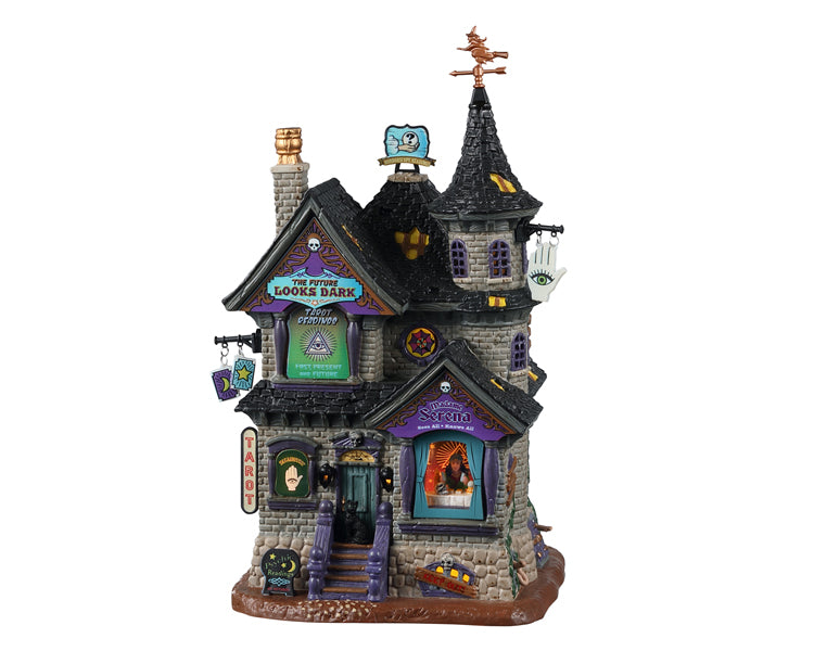 Lemax Spooky Town The Future Looks Dark #25857 - a black and grey stone purple with many purple and teal signs and accents entices customers for tarot readings. A copper witch weather vane sits atop the structure.