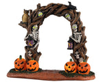 Horror Arch is a lighted table piece with lots of creepy details. It's a twisted tree archway with several skeletons embedded into the wood. The skeletons have lit-up green eyes and two of them are holding lanterns to welcome those who dare to walk through. You can also see glowing Jack-o'-lanterns, a crow, and a very alert owl.