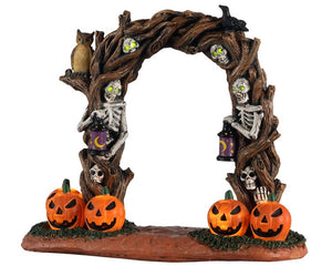 
            
                Load image into Gallery viewer, Horror Arch is a lighted table piece with lots of creepy details. It&amp;#39;s a twisted tree archway with several skeletons embedded into the wood. The skeletons have lit-up green eyes and two of them are holding lanterns to welcome those who dare to walk through. You can also see glowing Jack-o&amp;#39;-lanterns, a crow, and a very alert owl.
            
        