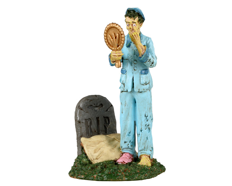
            
                Load image into Gallery viewer, Lemax Spooky Town Wake The Dead #32191 - A zombie wearing light blue pajamas looks into a mirror while standing above their tombstone which has a tan pillow resting on it.
            
        