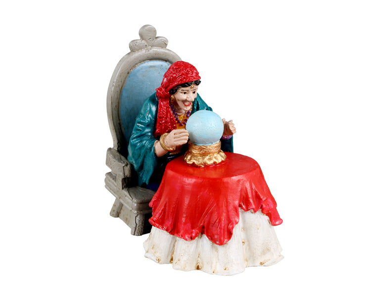 
            
                Load image into Gallery viewer, Lemax Spooky Town Madame Inez #32199 - A fortune telling old lady sits in a light blue chair while looking into her crystal ball.
            
        