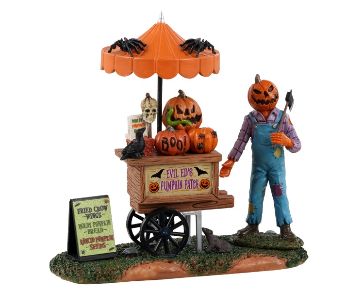 Lemax Spooky Town Pumpkin Patch Vendor #33611 - A jack o' lantern creature wearing overalls and a flannel shirt holds an axe and stands next to his pumpkin cart.