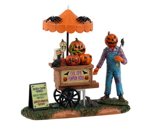 
            
                Load image into Gallery viewer, Lemax Spooky Town Pumpkin Patch Vendor #33611 - A jack o&amp;#39; lantern creature wearing overalls and a flannel shirt holds an axe and stands next to his pumpkin cart.
            
        