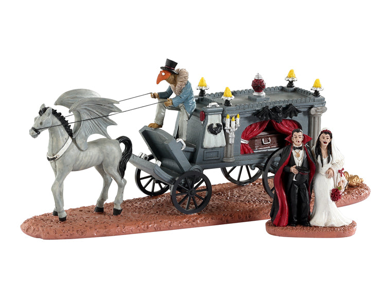 Lemax Spooky Town Newly Deads #33613 - A birdman in a plague outfit holds the reigns to a winged horse while two vampires smile after their wedding in front of their hearse.