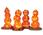 4 stacks of jack-o'-lanterns piled three or four high illuminate the night! 