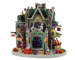 Lemax Spooky Town Gothic Hills Funeral Parlor #35002 - A stone building with a green roof is crawling with skeletons, gargoyles and jack o' lanterns.