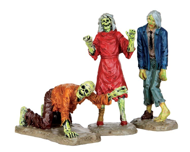 A set of 3 zombies search for their next victim, two are hunched over but standing while one is crawling.