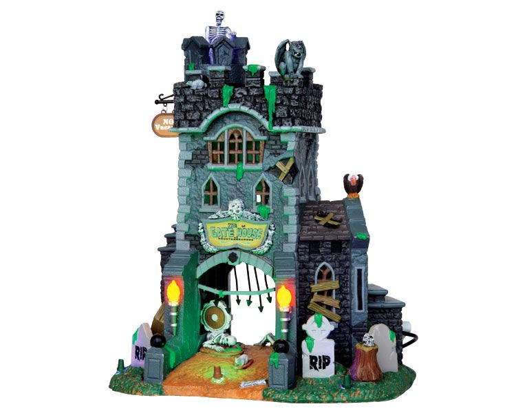 A stone Tower is covered in skeletons and garagoyles. A large sign sits on the front and reads "The Gate House at Haunted Meadows." Green slime also covered the structure.