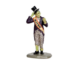 A green monster with a top hat has an orange and white sash around him that reads "mayor".