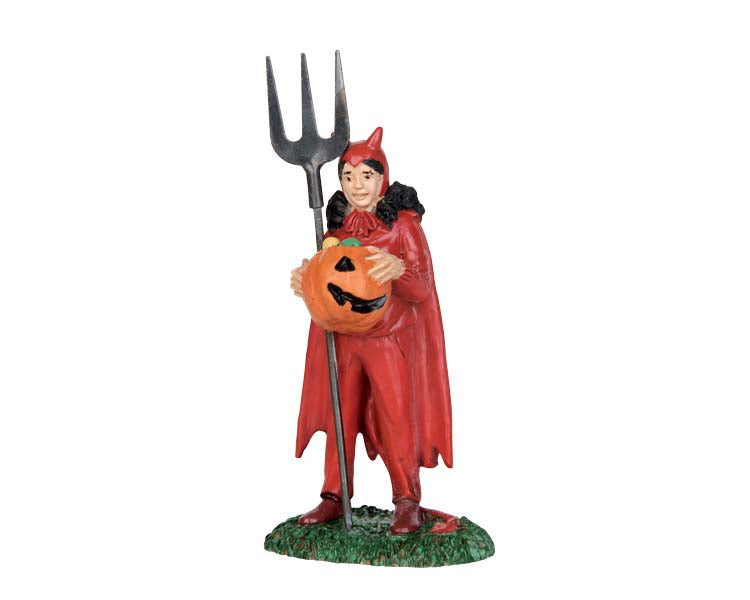 A girl wearing a devil costume holding a metal spear weapon and a jack-o'-lantern trick or treat bucket smiles.