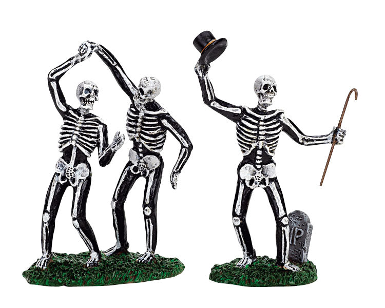 Three skeletons dance in a cemetery. One raises their top hat and cane while the other two do the tango. 