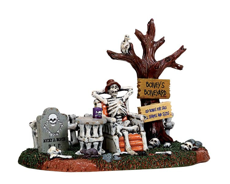 
            
                Load image into Gallery viewer, A relaxed skeleton sits in an orange bone chair surrounded by bones, tombstones and a withered tree. 
            
        