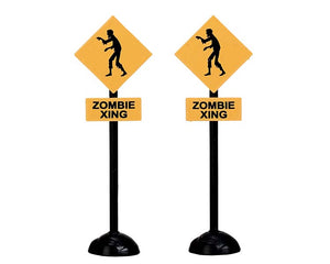 
            
                Load image into Gallery viewer, Two black and gold zombie crossing road signs. 
            
        