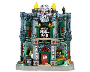 
            
                Load image into Gallery viewer, A skull themed green and grey two story bar is illuminated by flames that glow on the rooftop, eyes of a skull that light up and flashing lights on different sceneries like monsters drinking inside the bar.
            
        