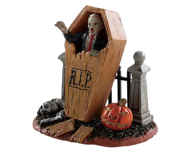 
            
                Load image into Gallery viewer, A zombie comes back from the dead by breaking out of their coffin which is leaning up against a small metal fence and a jack o&amp;#39; lantern. 
            
        