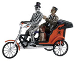 A skeleton drives a pedicab while Frankenstein and his dog ride in the back of the orange cart.