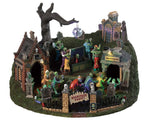 A large graveyard scene full of zombie / skeleton monsters partying under a disco ball. Coffin lids open and figures pop up, ballroom dancers twirl while circling coffins, while other dancers move in and out of  a mausoleum and figures shoot up behind tombstones in front. 