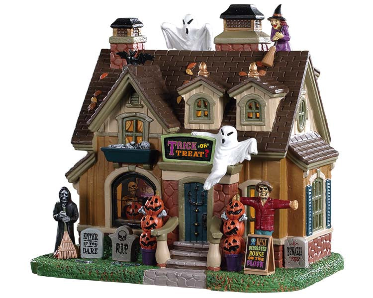 A classic home is crawling in monsters like the witch and ghosts on the roof, scarecrow and reaper in the front yard and skeleton in the main window. There are also decorative pumpkins and tombstones on both sides of the front steps. All of this makes for one creepy house.