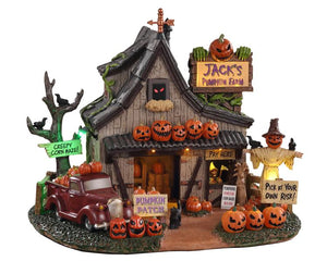 A creepy farm building is covered in jack-o'-lanterns, and accented with a scarecrow, pumpkin truck, trees and multiple spooky signs. Additionally, Glowing eyes peek out of window, while the signboard on the rooftop and 3 pumpkins up front light up.