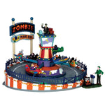 A carnival ride called the Zombie Plane ride is full of costumed children sitting in mini airplanes riding around the center tower maned by a zombie. 