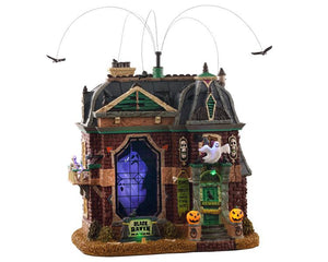 
            
                Load image into Gallery viewer, A spooky brick building. Inside, a crowd of ghosts rotate, while outside ravens revolve above the rooftop and pumpkins out front light up.
            
        