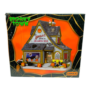 Retired Lemax Spooky Town Grimsley's House Of Halloween Decor #15193 - A creepy building has a sign that reads Grimsley's House of Halloween Decor; the building is covered in jack o' lanterns, black cats and monsters.