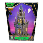 Retired Lemax Spooky Town Spooky Time #65345 - A gothic castle covered in gargoyles has a witch and ghosts lying above it. 