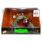 Retired Lemax Spooky Town Bat Lair #93724. Dracula stands with a candle in front of a cave.