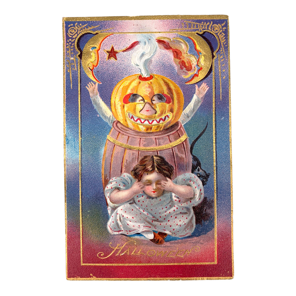 A girl hides beneath a pumpkin on a vintage halloween postcard.