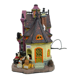 
            
                Load image into Gallery viewer, Retired Lemax Spooky Town Full Moon Apothecary #85664 - A witch flys over a purple and orange cottage shop.
            
        