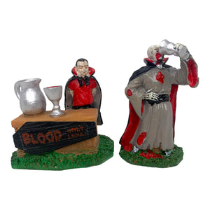 Retired Lemax Spooky Town Ghoulish Refreshments #82463 - A vampire sells blood to another vampire at a stand that has a sign that reads "BLOOD Only 1 Soul!"