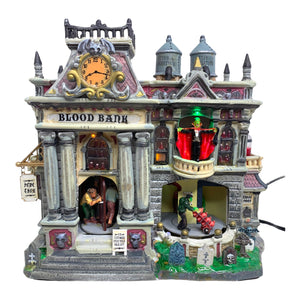
            
                Load image into Gallery viewer, Retired Lemax Spooky Town The Blood Bank #55239 - A stone building is crawling in monsters including ghouls and vampires. A sign above the door reads Blood Bank.
            
        